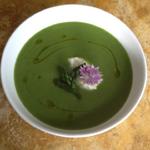 Fresh asparagus soup with wild chive flower and creme fraiche